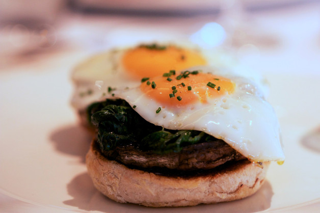 Spinach field mushrooms fried eggs and toasted muffin brunch